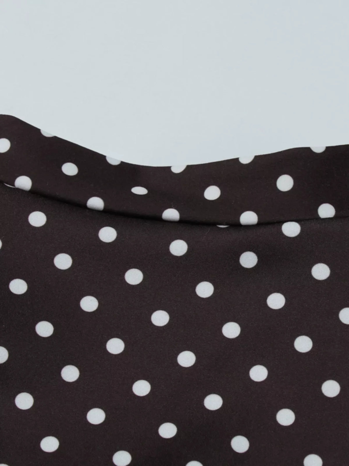 Polka dot cut-out front mini dress by Plush Fashion Hub featuring a stylish design and playful polka dot pattern.