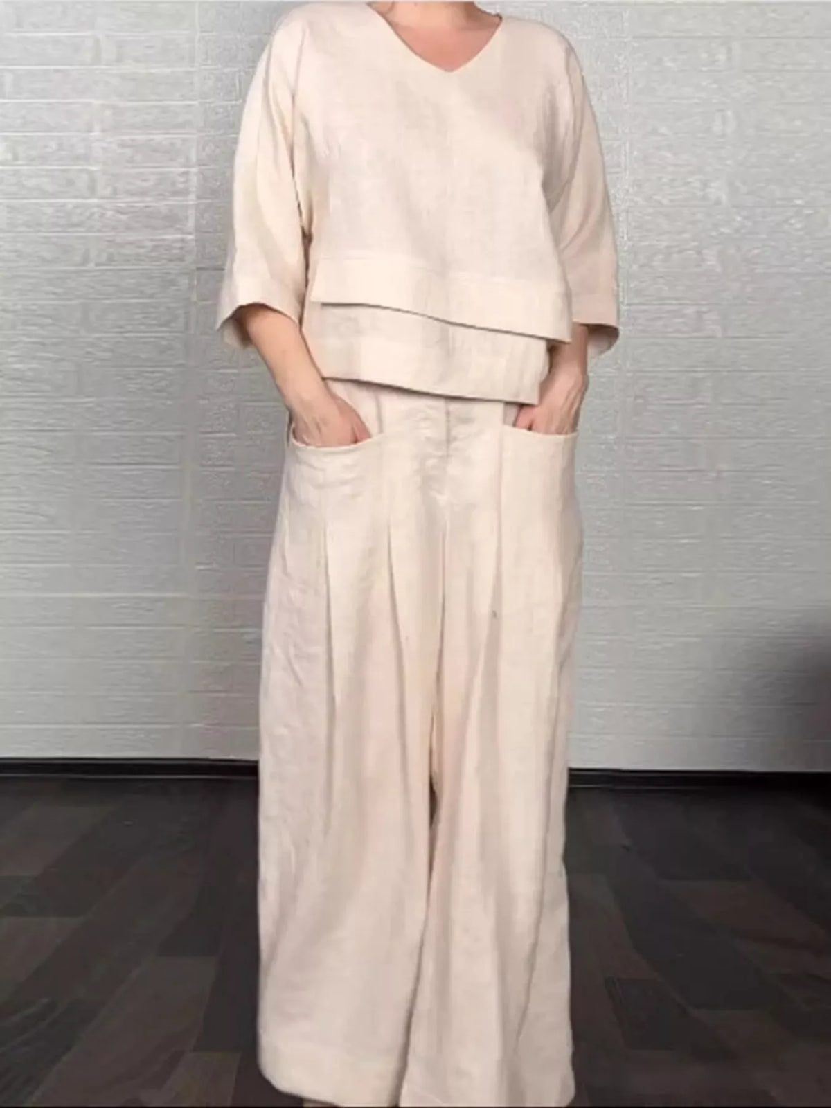 Plus size full V-neck long sleeve top and pants set, trendy matching outfit by Trendsi, shown in a stylish, comfortable fabric.
