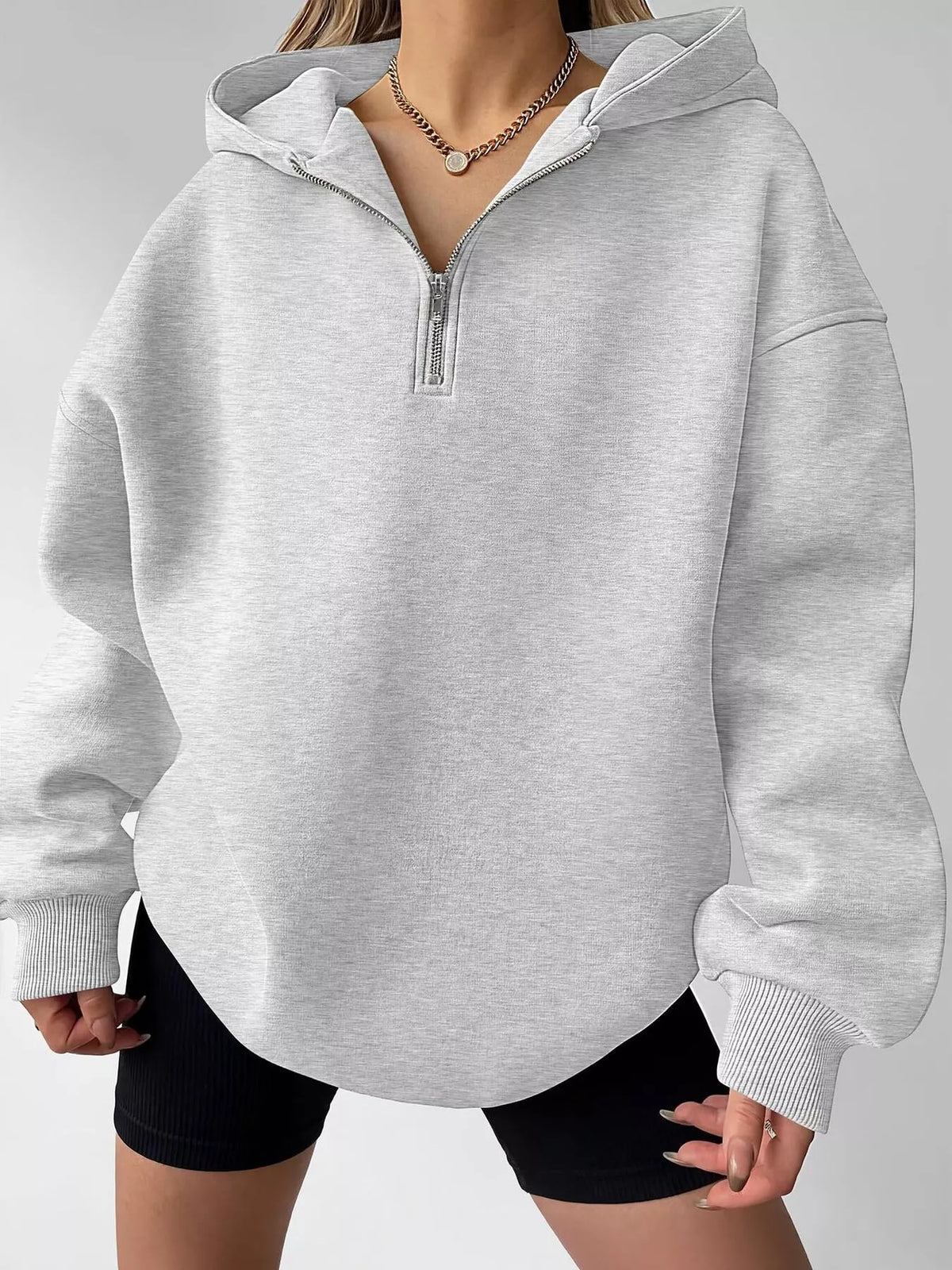 Oversized quarter-zip hoodie from Trendsi, featuring a relaxed fit and soft fabric, ideal for casual tops and comfortable wear.