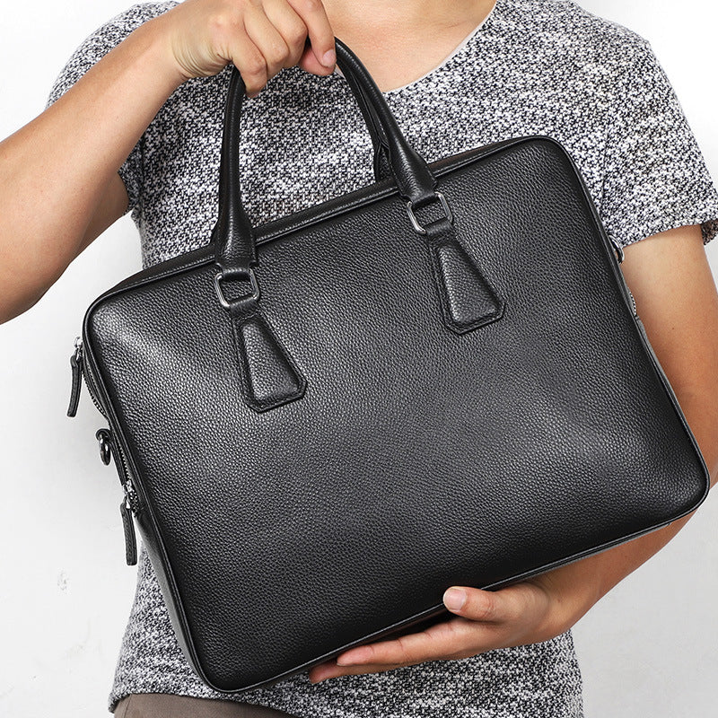 Men's leather briefcase by Pi-Mart, large capacity cowhide handbag with horizontal design and sturdy handles.