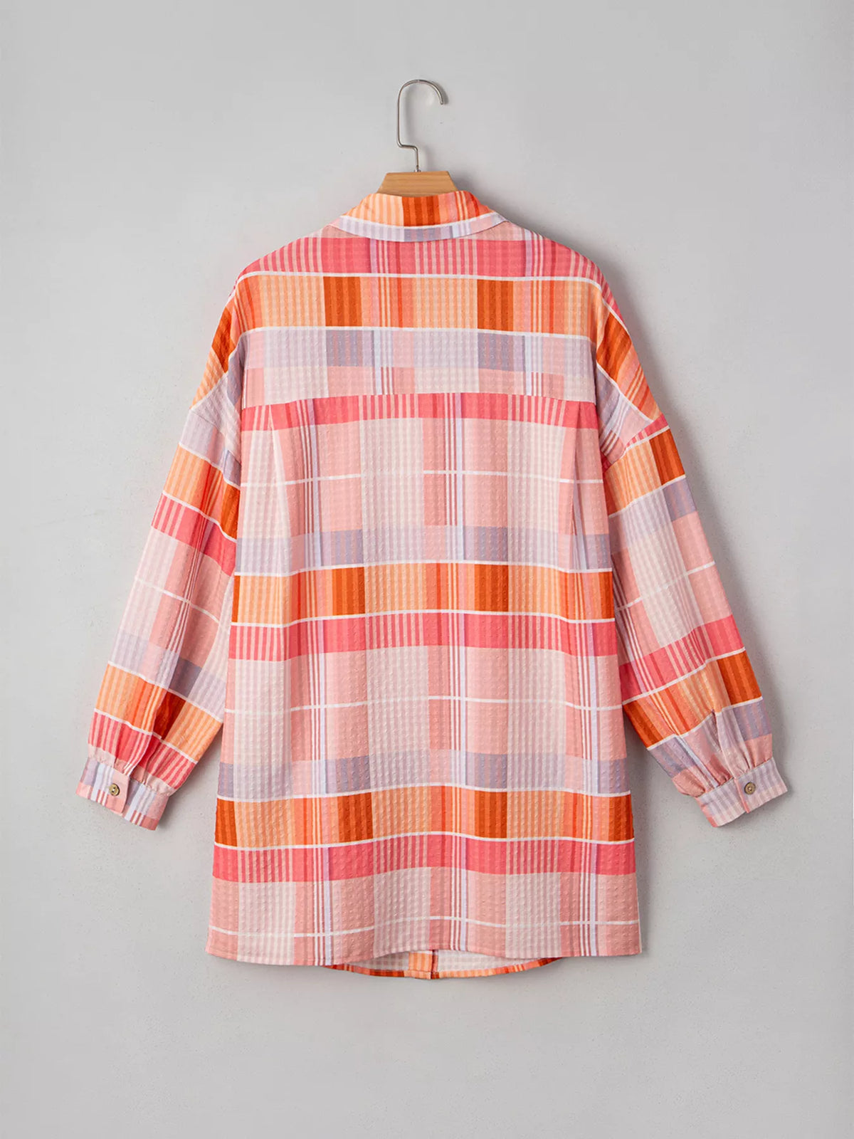Oversized check tunic shirt for women featuring a relaxed fit, with a plaid pattern and button-front design by Trendsi.