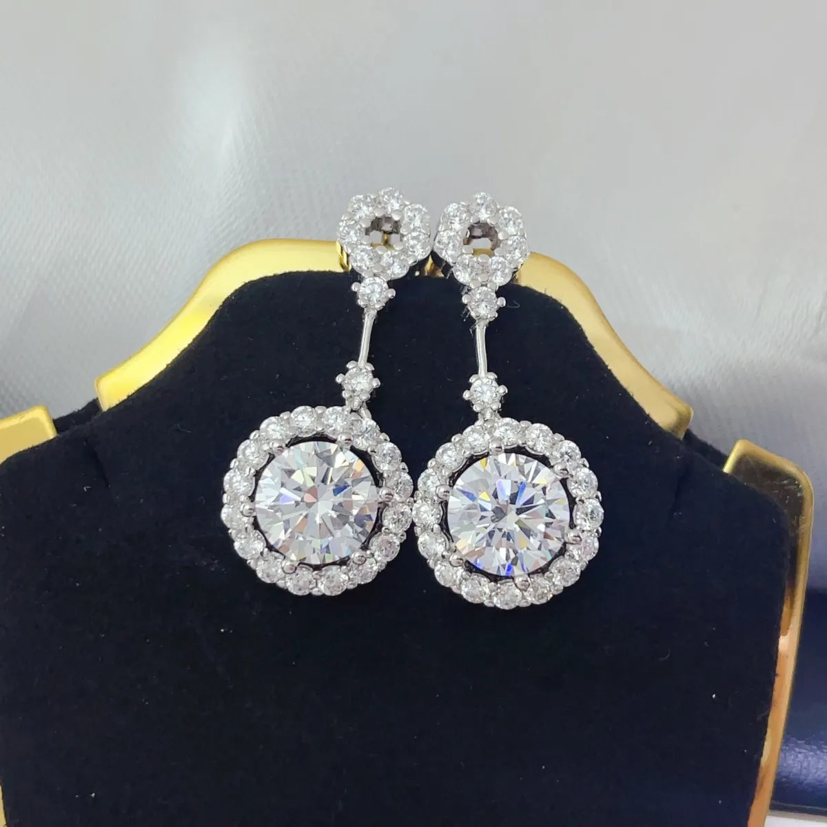 Plush Fashion Hub 4 Carat Crystal Drop Dangle Earrings with round halo design, featuring sparkling crystal drops and intricate metalwork.