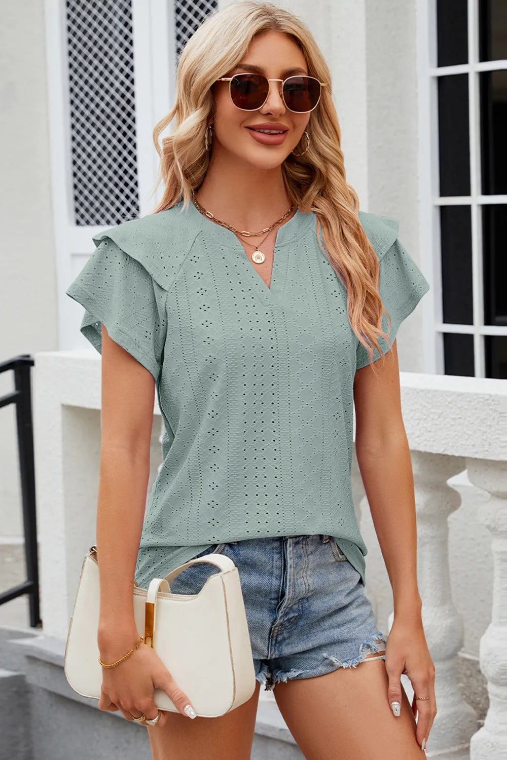 Plush Fashion Hub eyelet notched flutter sleeve T-shirt with relaxed fit and stylish design, shown in a soft fabric.