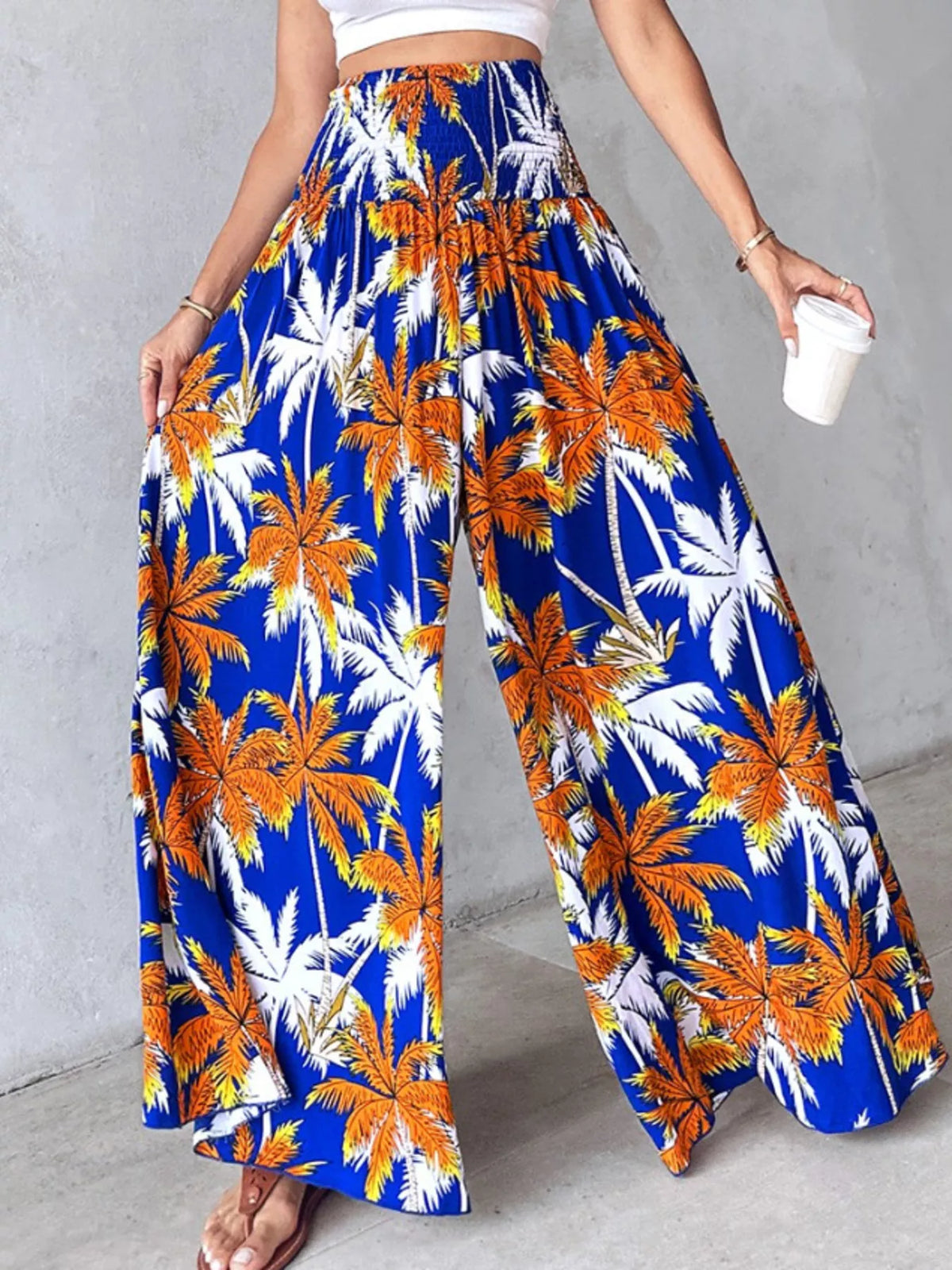 Printed wide-leg pants by Plush Fashion Hub featuring a colorful floral pattern and flowing, relaxed fit.
