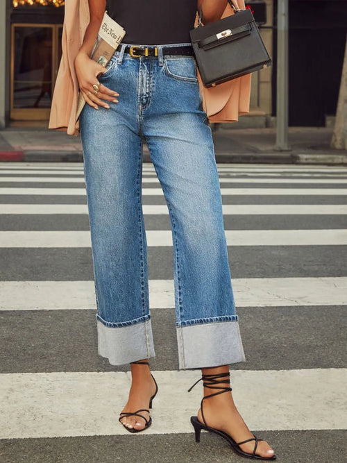 High waisted straight leg rolled denim jeans by Trendsi, showing the fit and rolled cuffs on a neutral background.