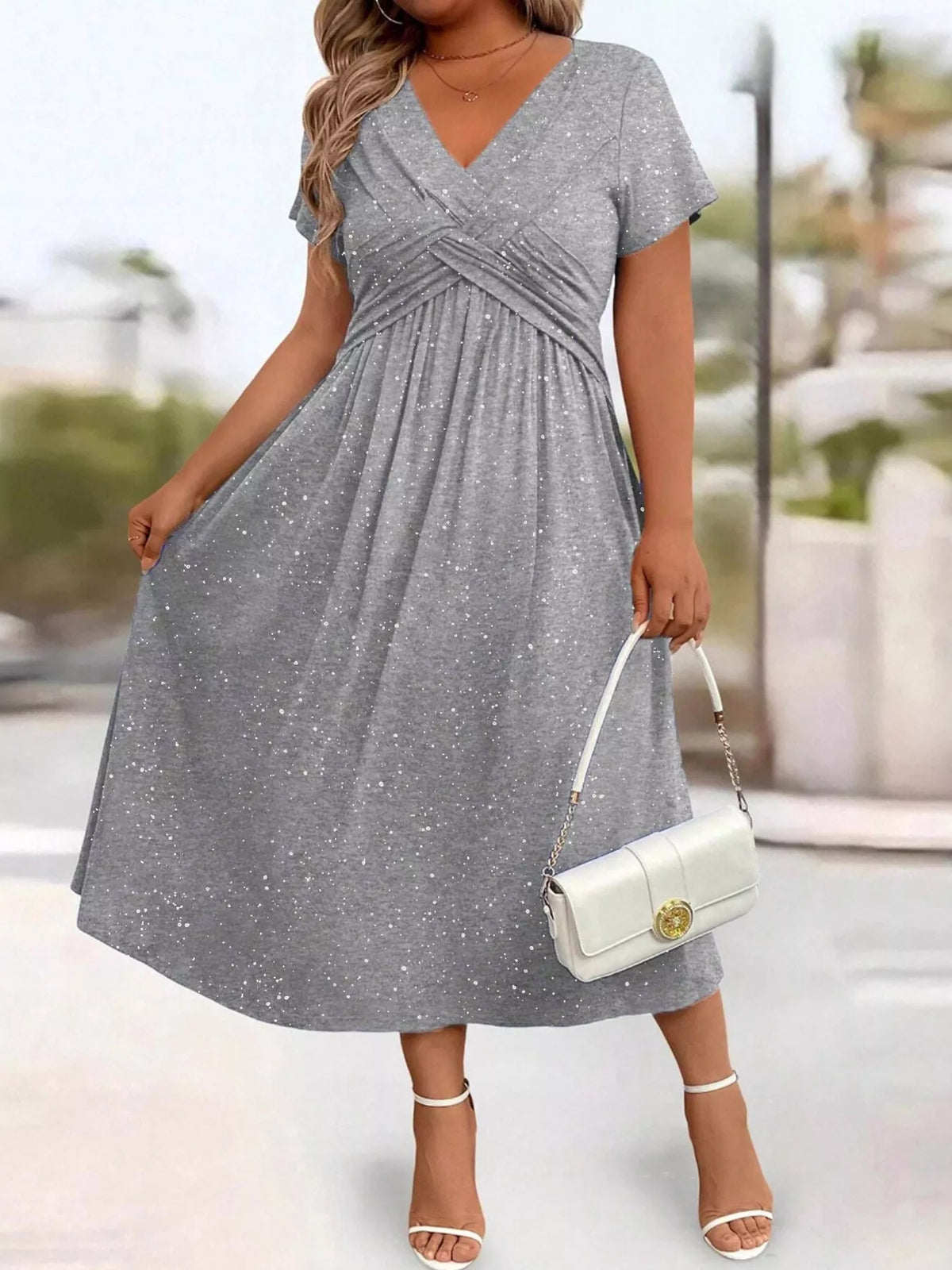 Plus size glitter flutter sleeve midi dress by Trendsi, showcasing a shimmering fabric and elegant flutter sleeves.