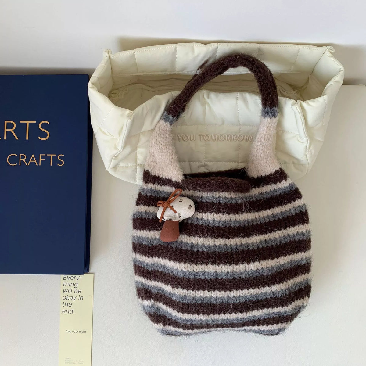 Knitted striped handbag by Plush Fashion Hub featuring colorful woven design and sturdy handles, perfect for casual carry.