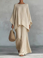 Plus size Trendsi full size round neck top and wide-leg pant set, featuring a comfortable, stylish matching clothing ensemble.