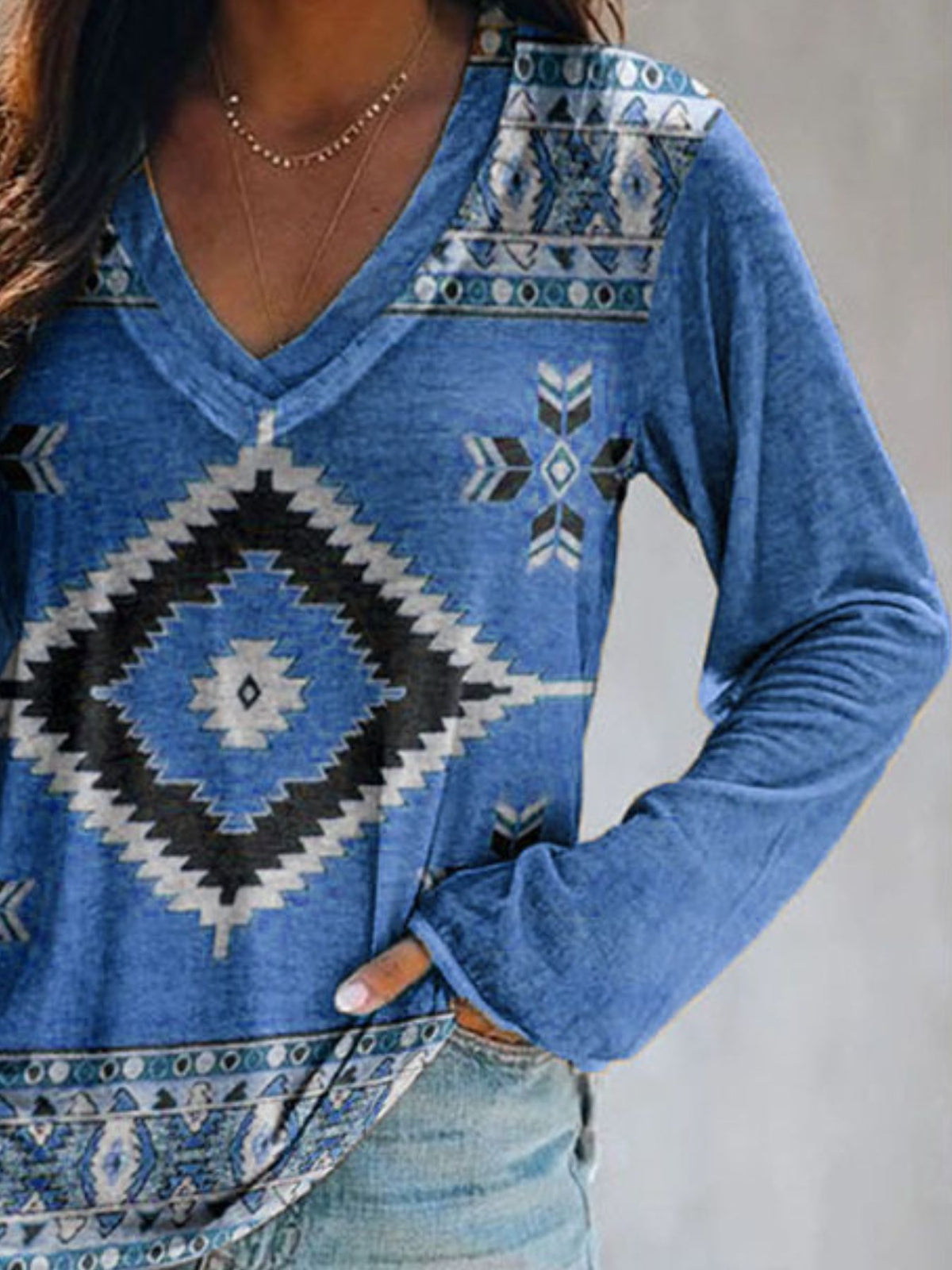 Plus size Plush Fashion Hub geometric print V-neck long sleeve T-shirt with casual fit and vibrant pattern.