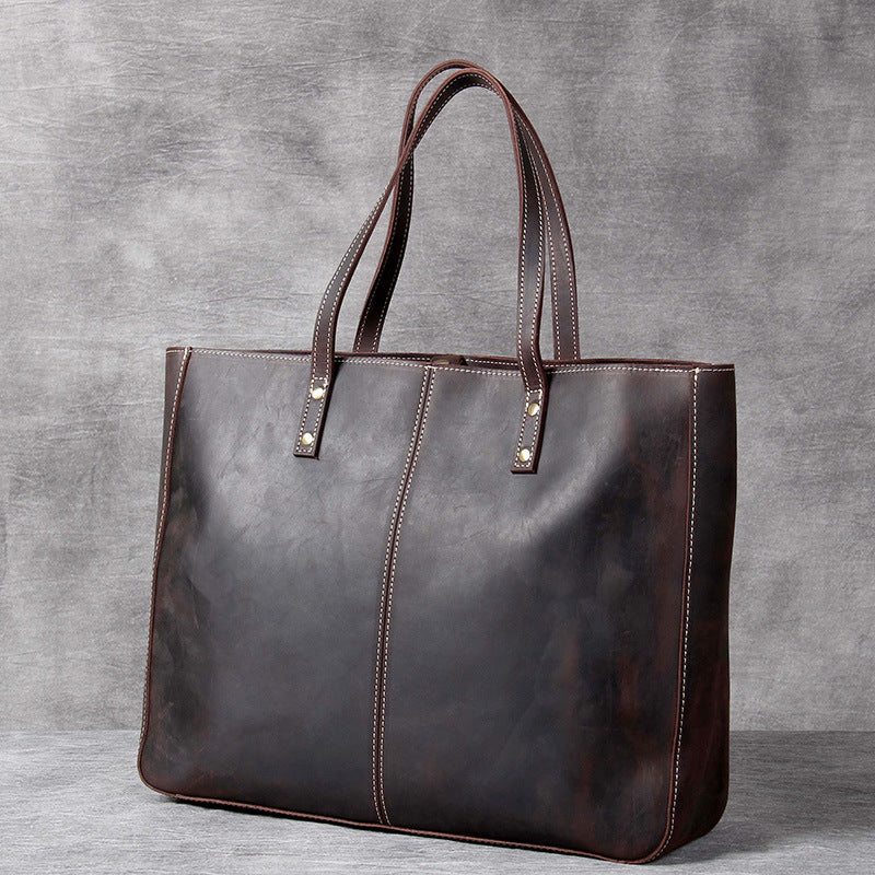 Pi-Mart retro cowhide large-capacity men's handbag with simple design and spacious interior, showcasing durable leather construction.