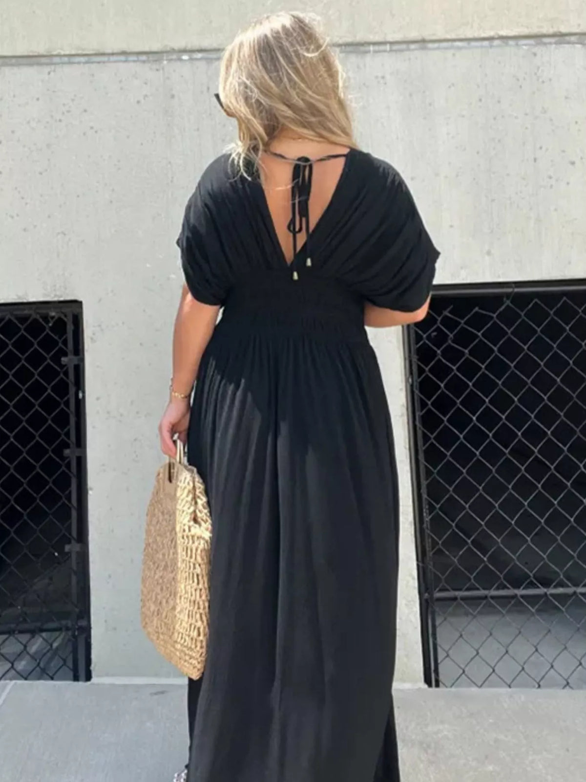 Plus size full slit V-neck maxi dress with smocked waist by Plush Fashion Hub, featuring flowing fabric and elegant design.