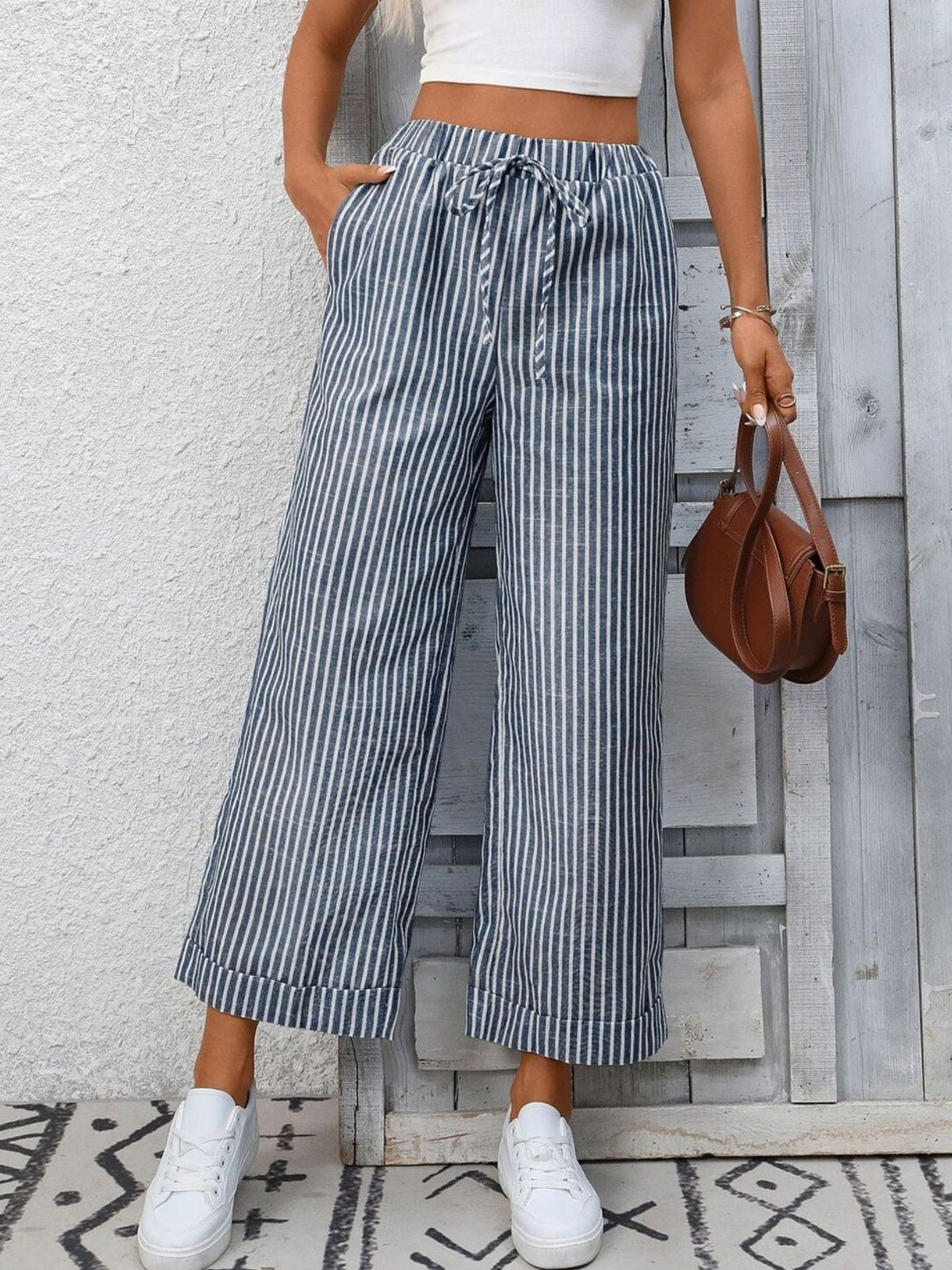 Women’s striped wide-leg drawstring pants with pockets by Plush Fashion Hub, featuring a relaxed fit and stylish design.