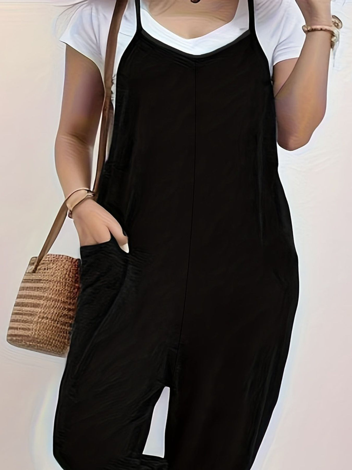 Casual loose-fit spaghetti strap jumpsuit with pockets from Plush Fashion Hub, shown in a relaxed fit with thin straps and side pockets.
