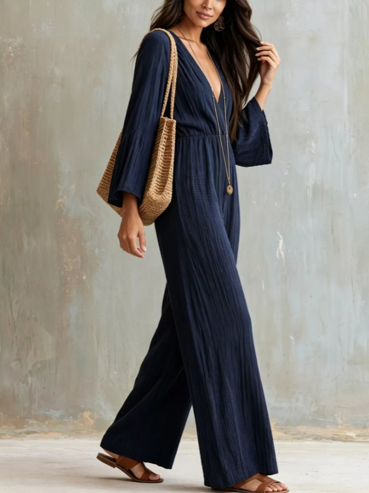 Textured flare sleeve women's jumpsuit by Trendsi, featuring a stylish fit and detailed fabric texture.