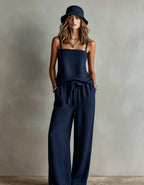 Women's casual two-piece set by FitiqueFit featuring a spaghetti strap cami top and wide-leg pants, styled for everyday wear.