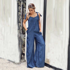 Women’s sleeveless wide-leg denim jumpsuit by FitiqueFit featuring a crew neck and casual style, shown on a model.