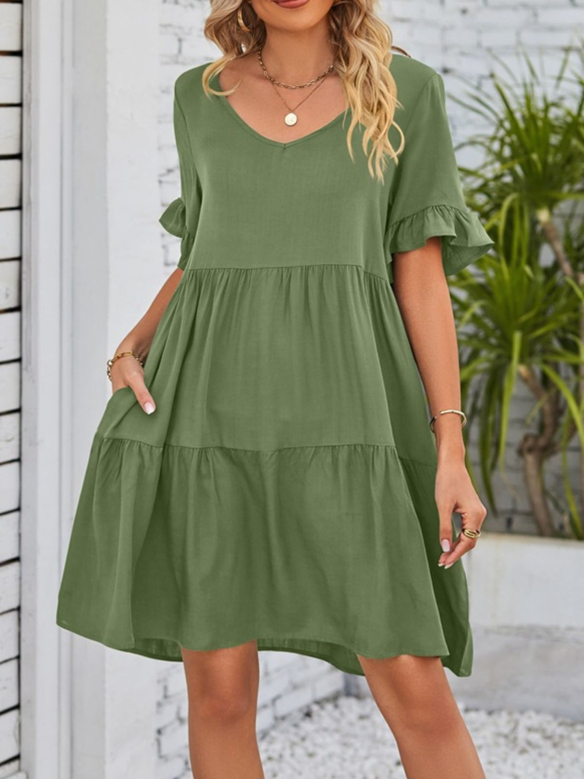 Lightweight rayon ruffled sleeve tiered mini dress with pockets by Plush Fashion Hub, showing its flowy fabric and stylish design.