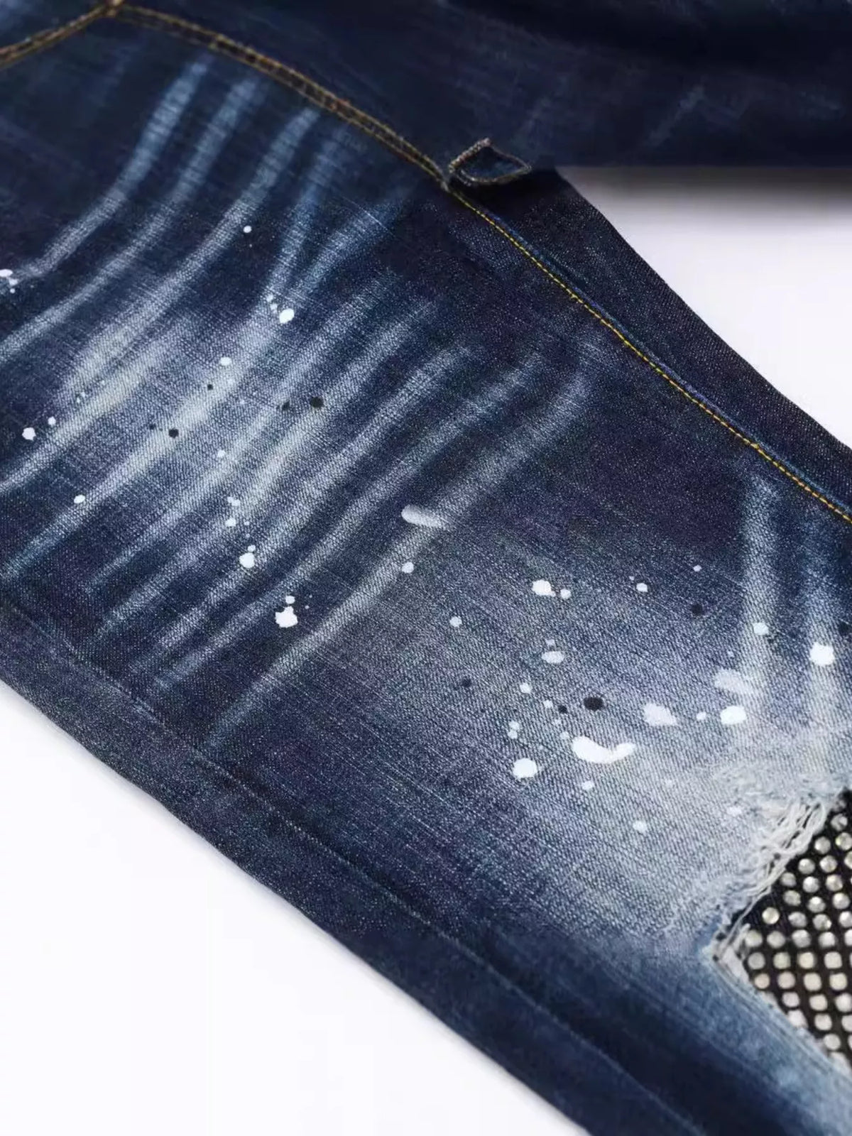 Men's distressed slim fit jeans by Plush Fashion Hub, featuring a faded denim look and trendy rips, on a neutral background.
