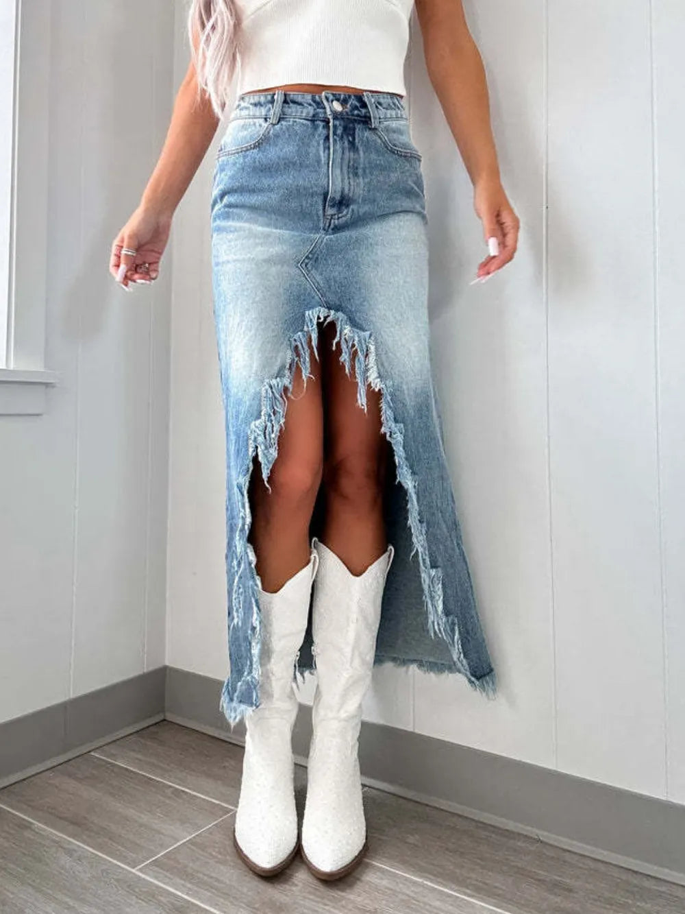 High-waist raw hem asymmetrical denim skirt by Trendsi, featuring distressed raw edges and a stylish asymmetrical design.