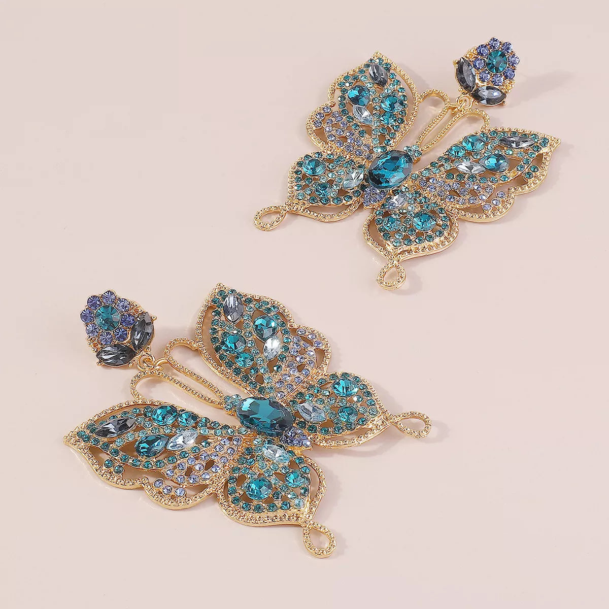 Plush Fashion Hub butterfly rhinestone dangle earrings with sparkling stones and intricate metalwork, hanging from fishhook findings.