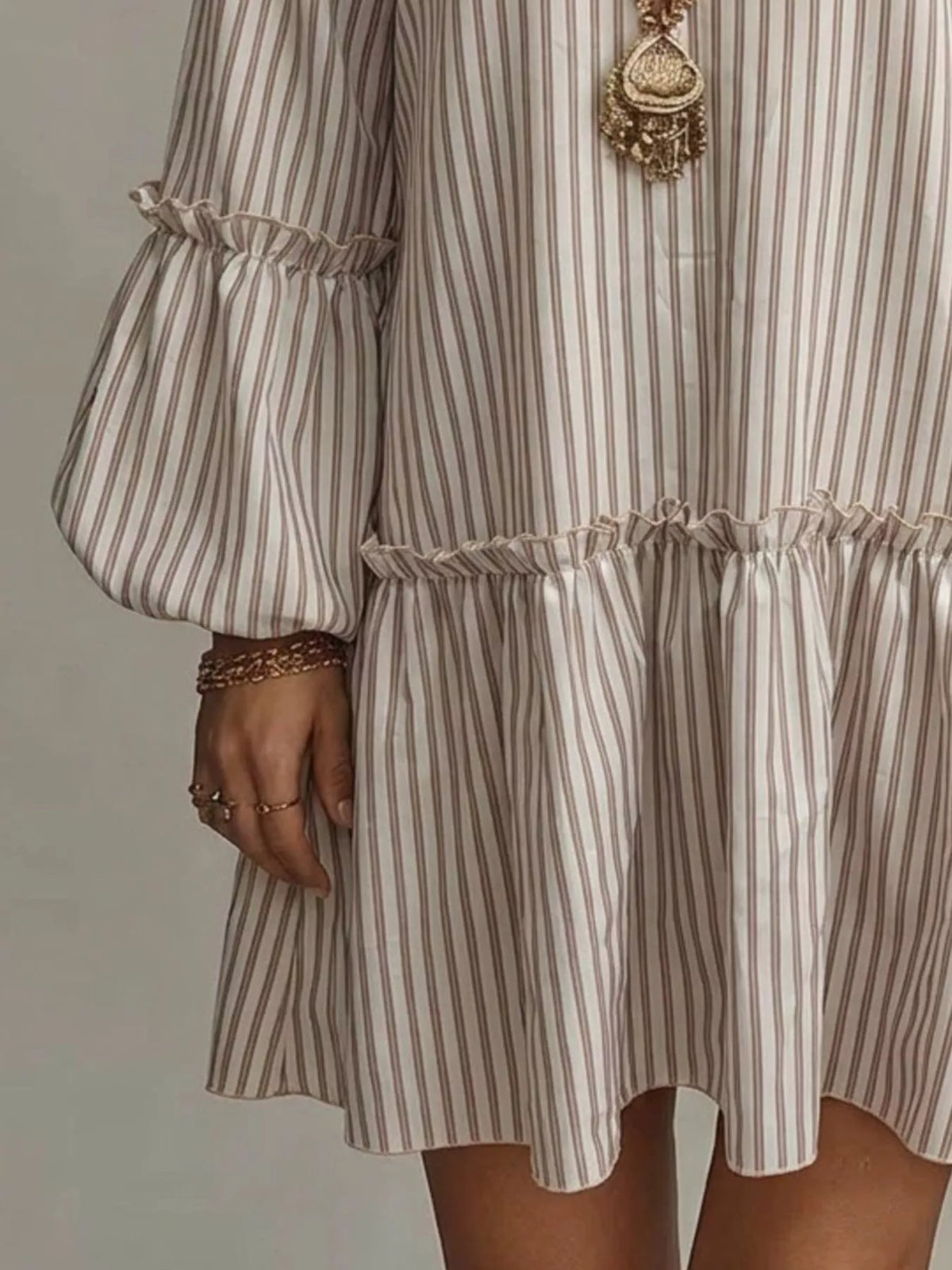 Plus size striped balloon sleeve mini dress by Trendsi, featuring a stylish full-size dress with bold stripes and trendy balloon sleeves.