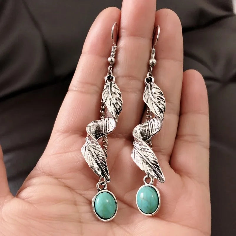 Turquoise alloy leaf earrings from Plush Fashion Hub featuring intricate leaf design and vibrant color.