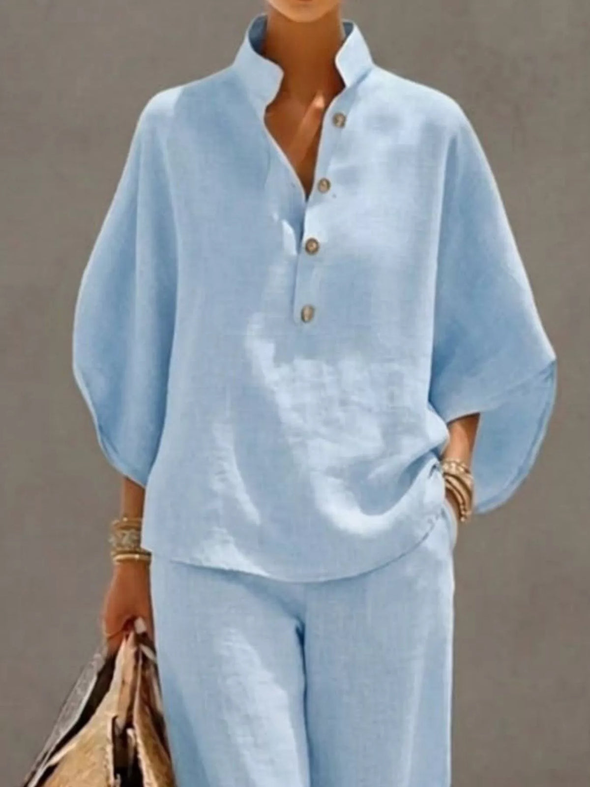 Plus size women's two-piece set featuring a button-detail top and matching pants with 3/4 sleeves, by Plush Fashion Hub.