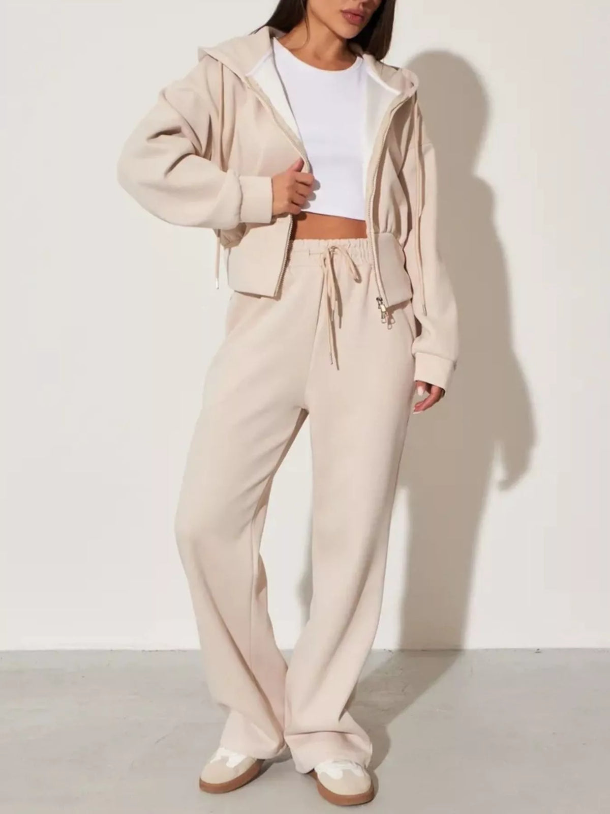 Plush Fashion Hub zip-up hoodie and wide-leg pants loungewear set, soft fabric with a relaxed fit, displayed on a hanger.
