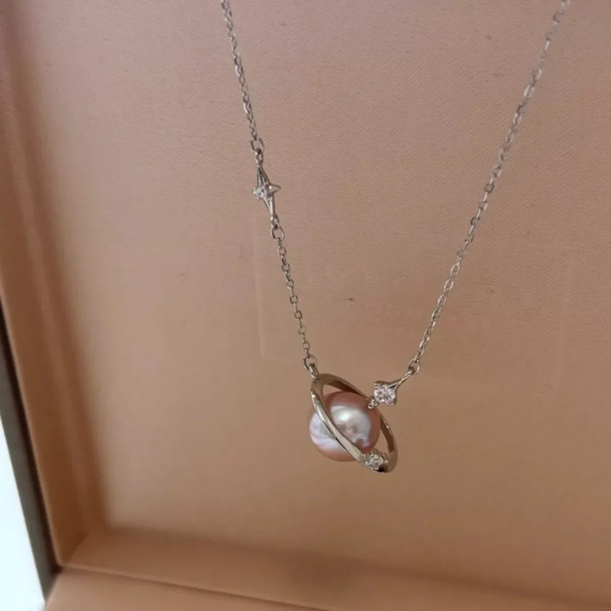 Plush Fashion Hub Planet Pearl Pendant Necklace featuring a luminous pearl pendant on a delicate chain.