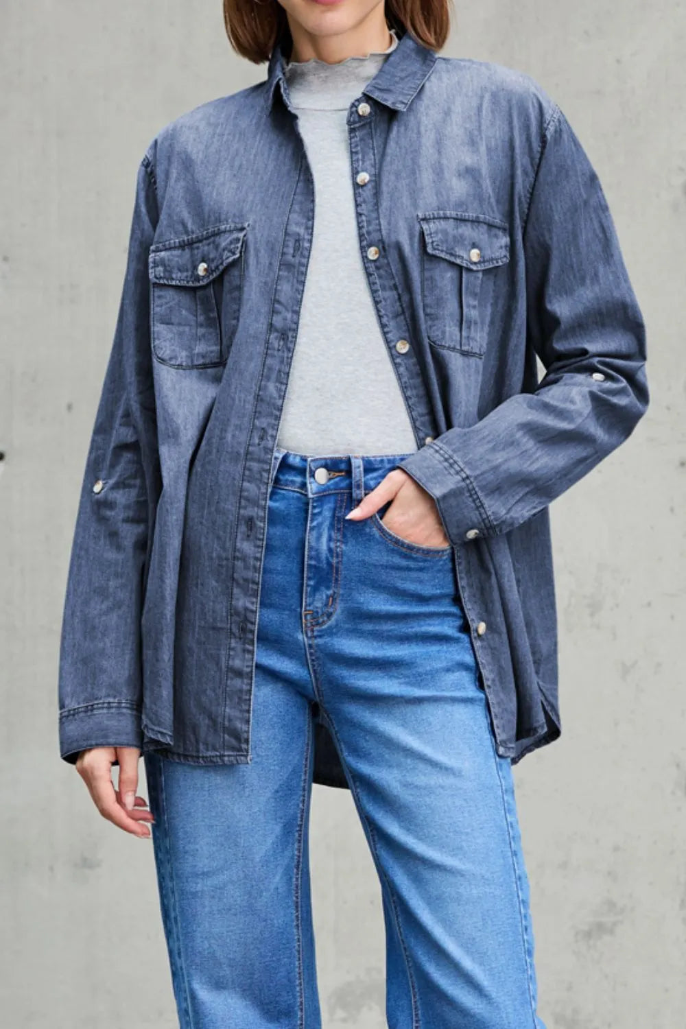 Trendsi denim top with long sleeves, collared neck, and front pockets, showcasing casual denim fashion for women.
