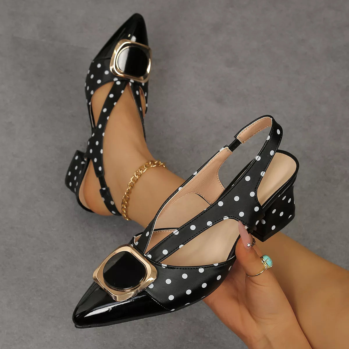 Polka dot slingback pumps with buckle accent by Trendsi, showing stylish heels with a polka dot pattern and elegant buckle detail.