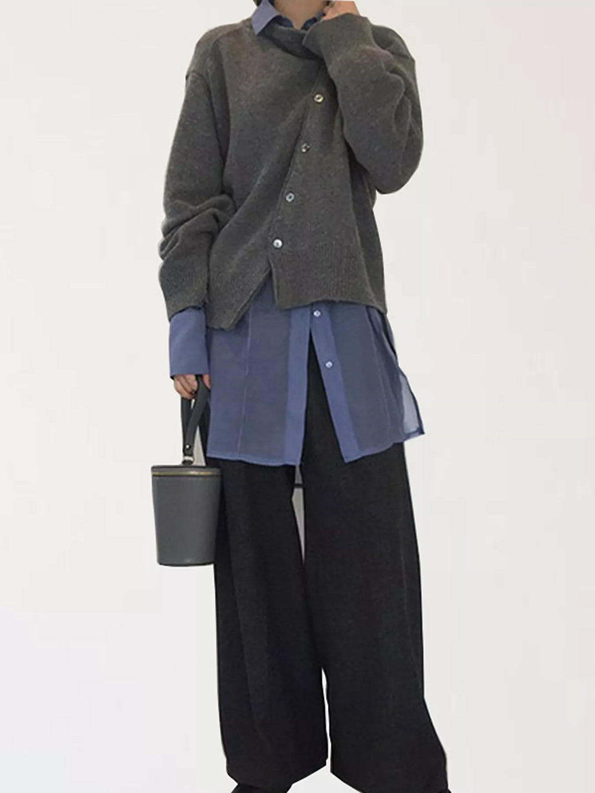 Asymmetric button-down sweater by Trendsi featuring a stylish, modern design with unique button details and soft knit fabric.