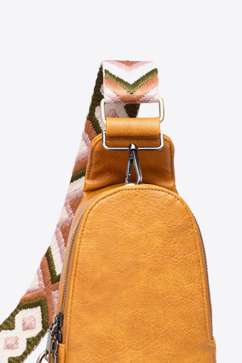 Black adjustable strap PU leather sling bag with random pattern design, trendy Trendsi sling bag for casual use.