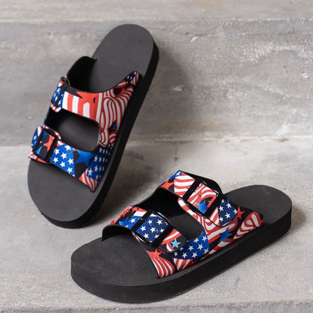 American flag patriotic double-strap flat sandals for women by Trendsi, featuring comfortable design and bold flag print.