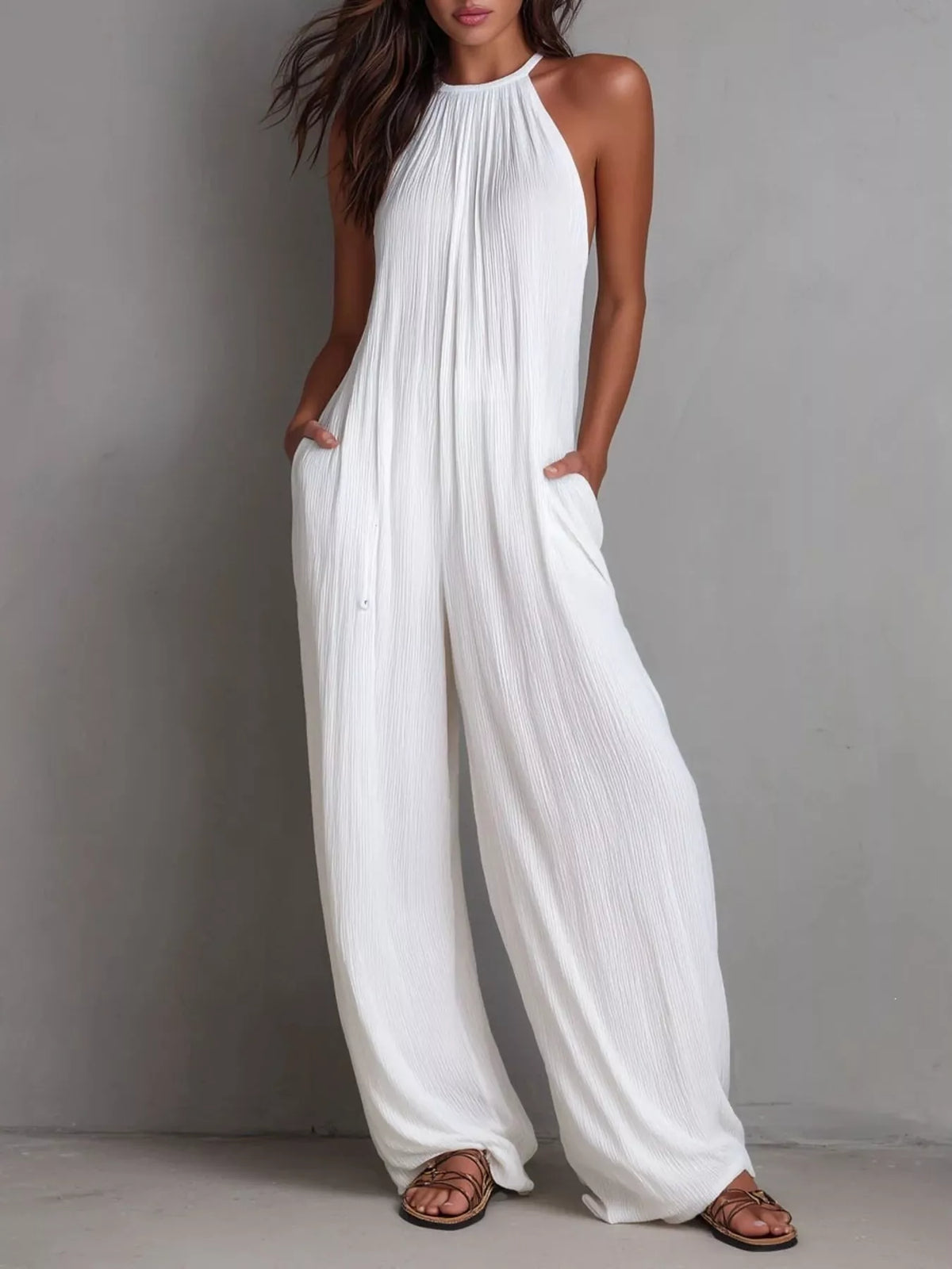 Plush Fashion Hub sleeveless wide-leg jumpsuit in lightweight fabric, shown on a model with a relaxed fit and modern style.