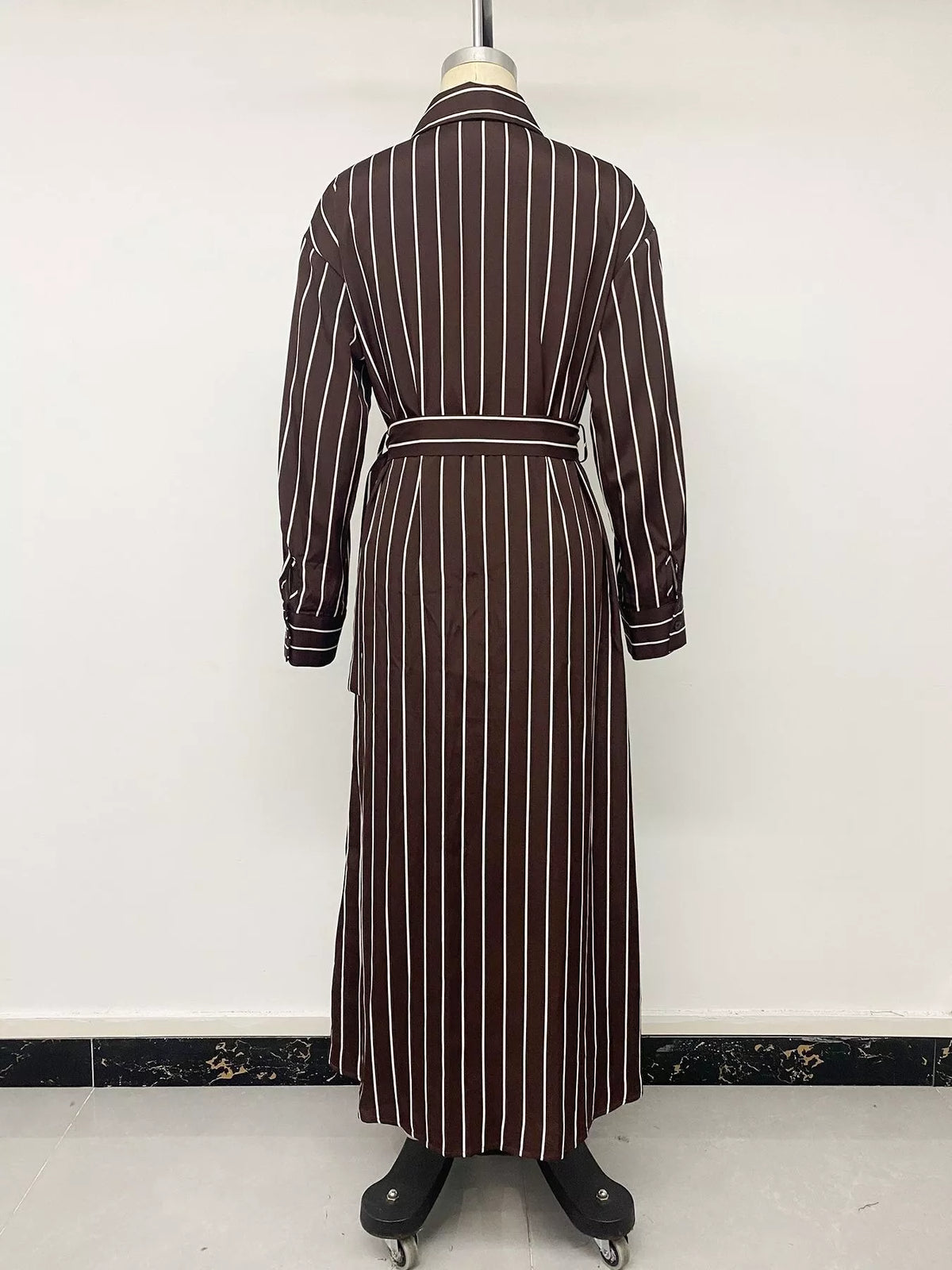 Striped long sleeve belted shirt dress for women by Trendsi, featuring a button-up front and waist tie, casual and stylish.