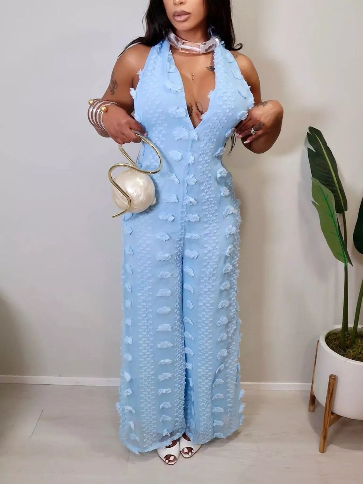 Textured halter wide-leg jumpsuit for women, featuring a stylish fit and trendy design, displayed on a mannequin.