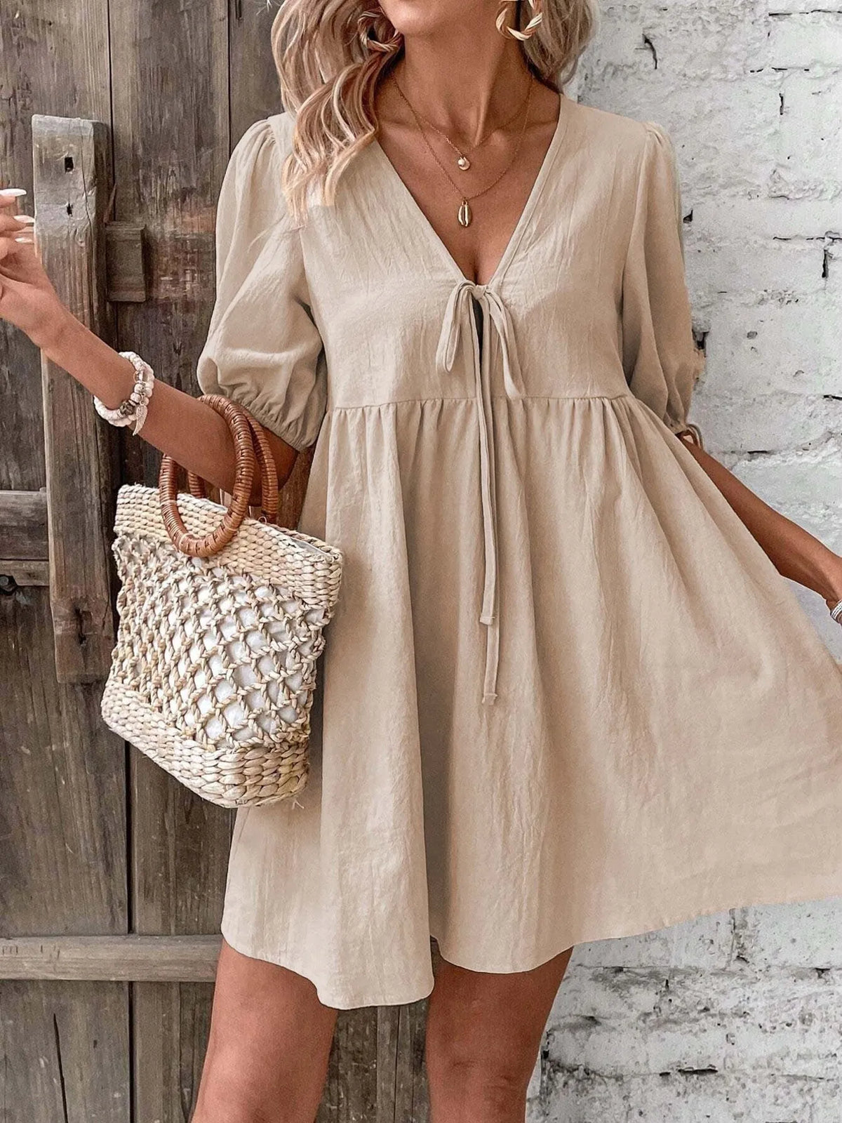 Cotton v-neck tie-front mini dress with puff sleeves by Plush Fashion Hub, featuring a stylish and comfortable fit.