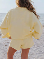 Relaxed fit round neck sweatshirt and matching shorts set by Trendsi, casual loungewear in soft fabric, shown on a model.