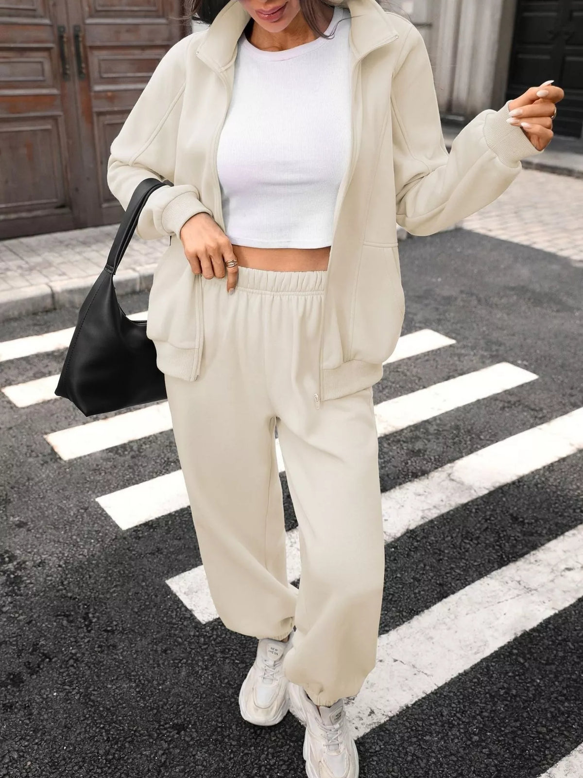 Women's zip-up long sleeve top and pants set by Trendsi, featuring a coordinated, comfortable casual outfit with a fitted style.