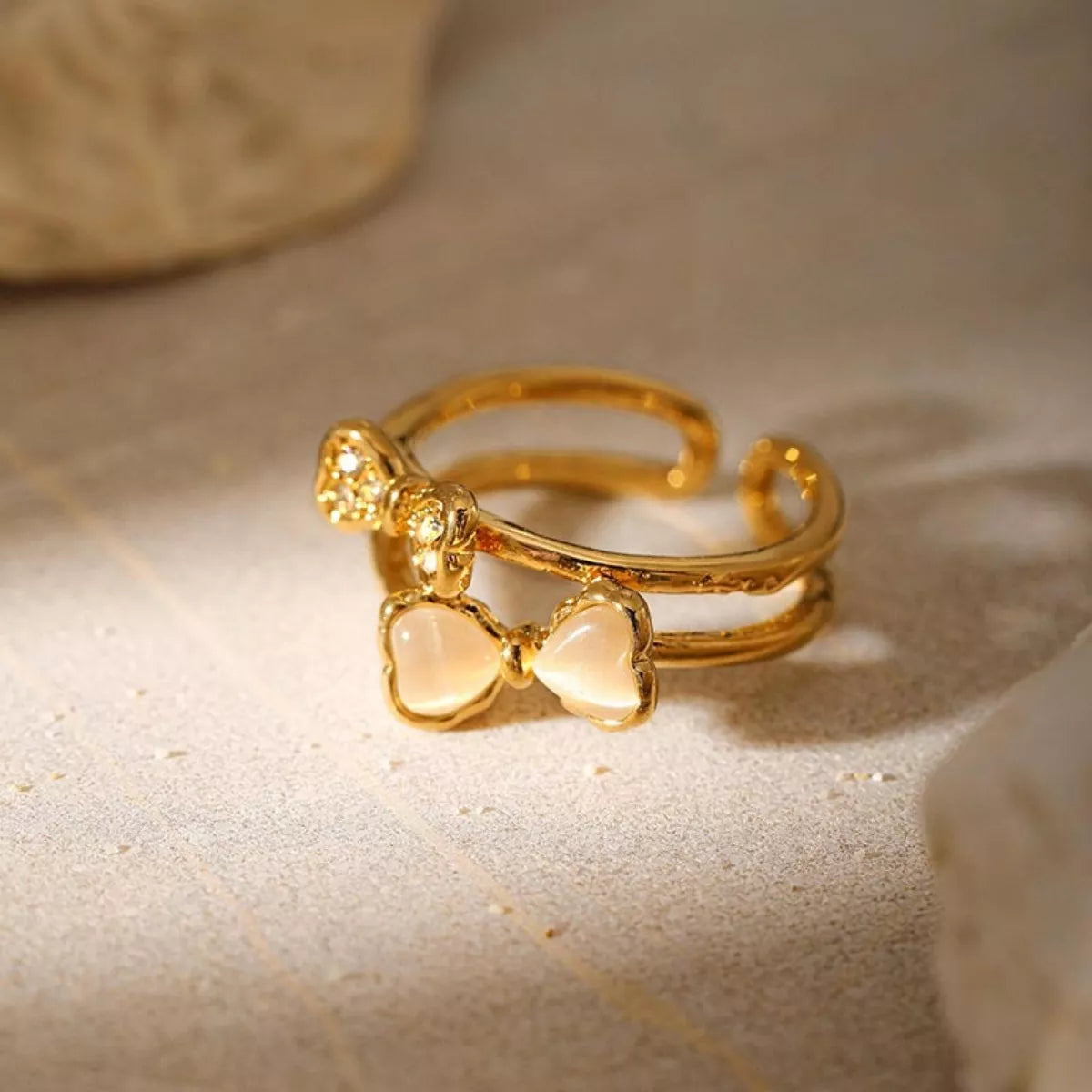 18K gold-plated bow open ring from Plush Fashion Hub featuring a delicate, stylish design with a shiny gold finish.