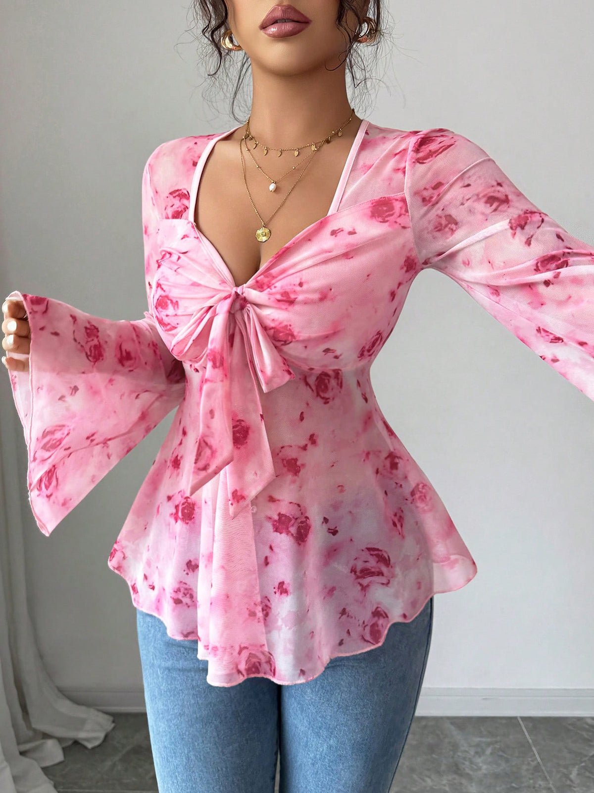 Floral print tie-front chiffon blouse with flare sleeves by Plush Fashion Hub, shown with flowing fabric and vibrant floral pattern.