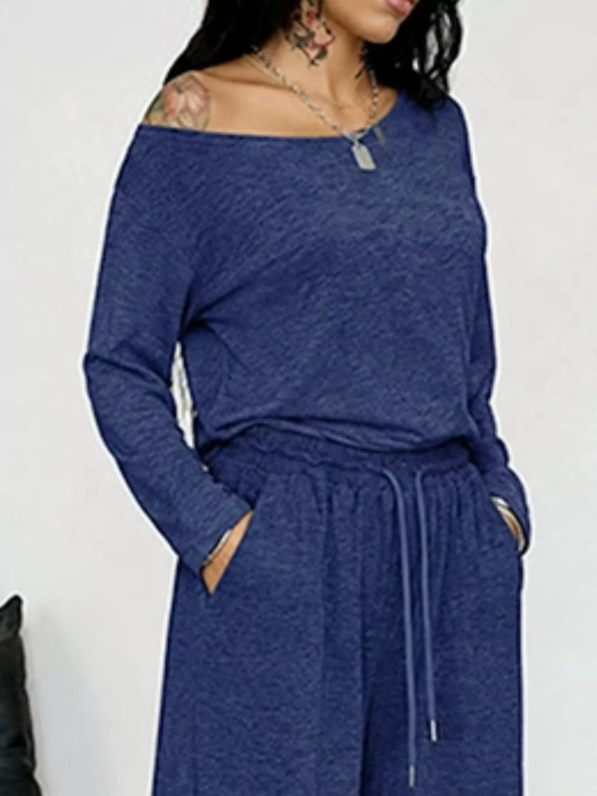 Plus size loose fit one-shoulder T-shirt and pants matching set by Trendsi, casual and comfortable activewear ensemble.
