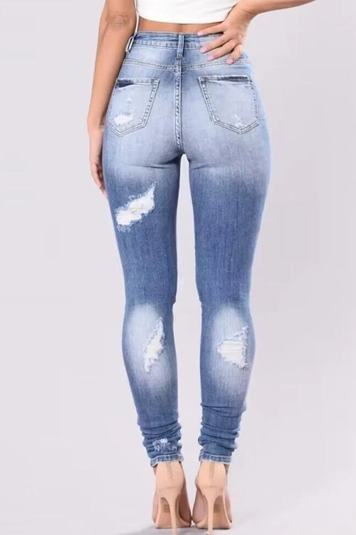 Plus size distressed skinny denim jeans by Trendsi, full length with a fitted, trendy distressed look and classic jean details.