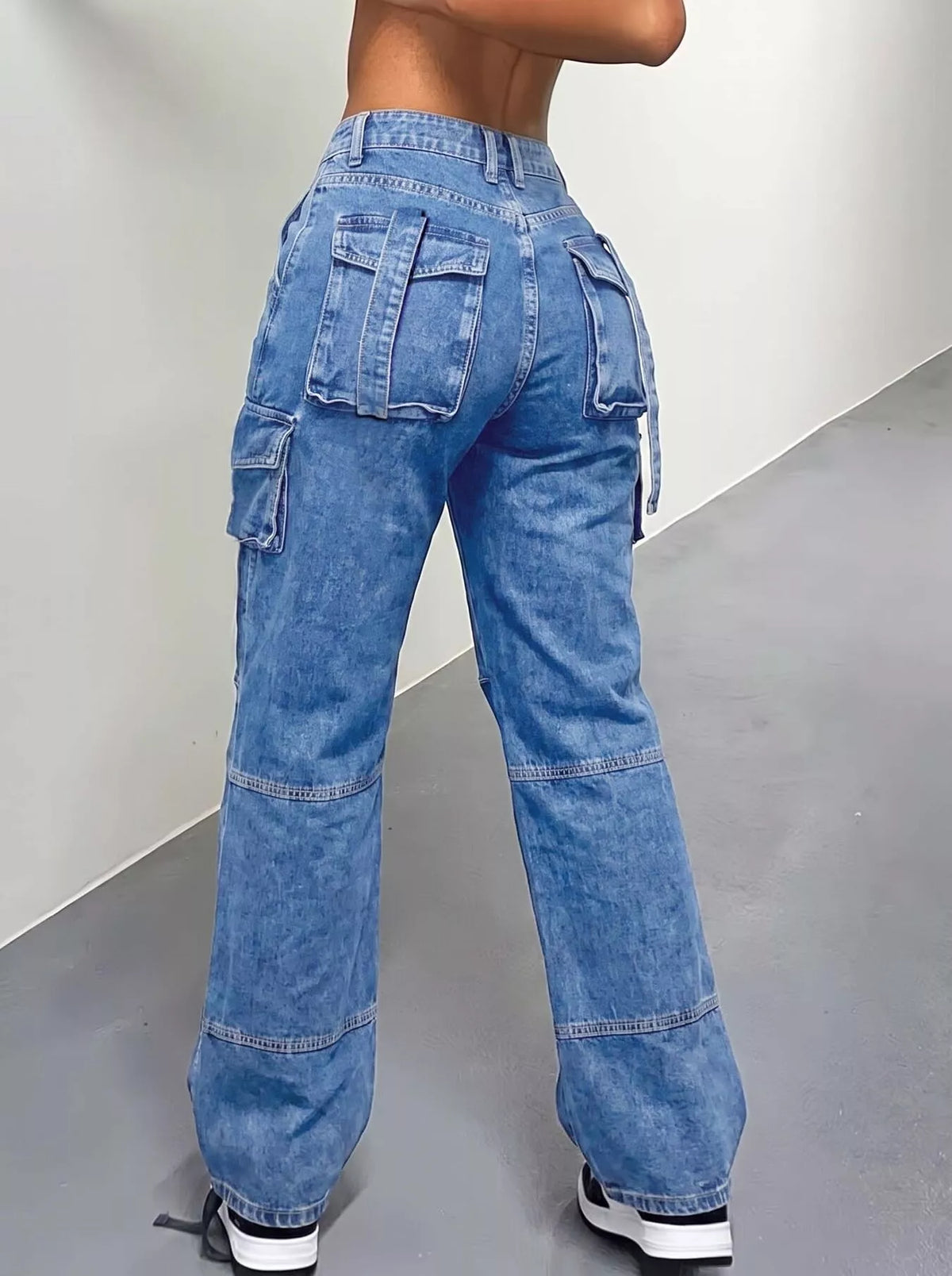 High-waisted distressed cargo jeans by Trendsi, showcasing rugged denim with multiple pockets and a trendy, relaxed fit.