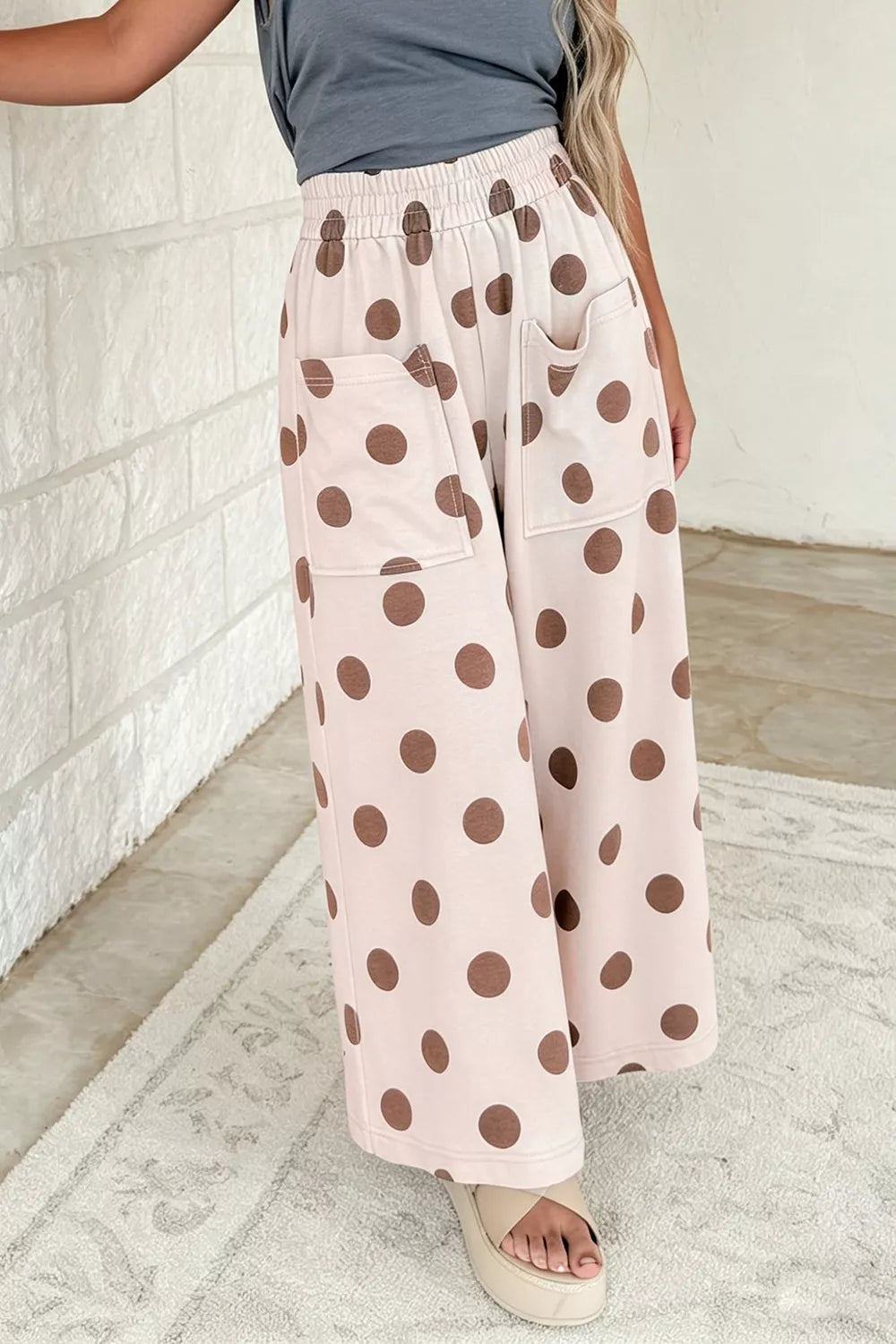 Polka dot wide leg casual pants with elastic waist by Trendsi, featuring a relaxed fit and playful polka dot pattern.