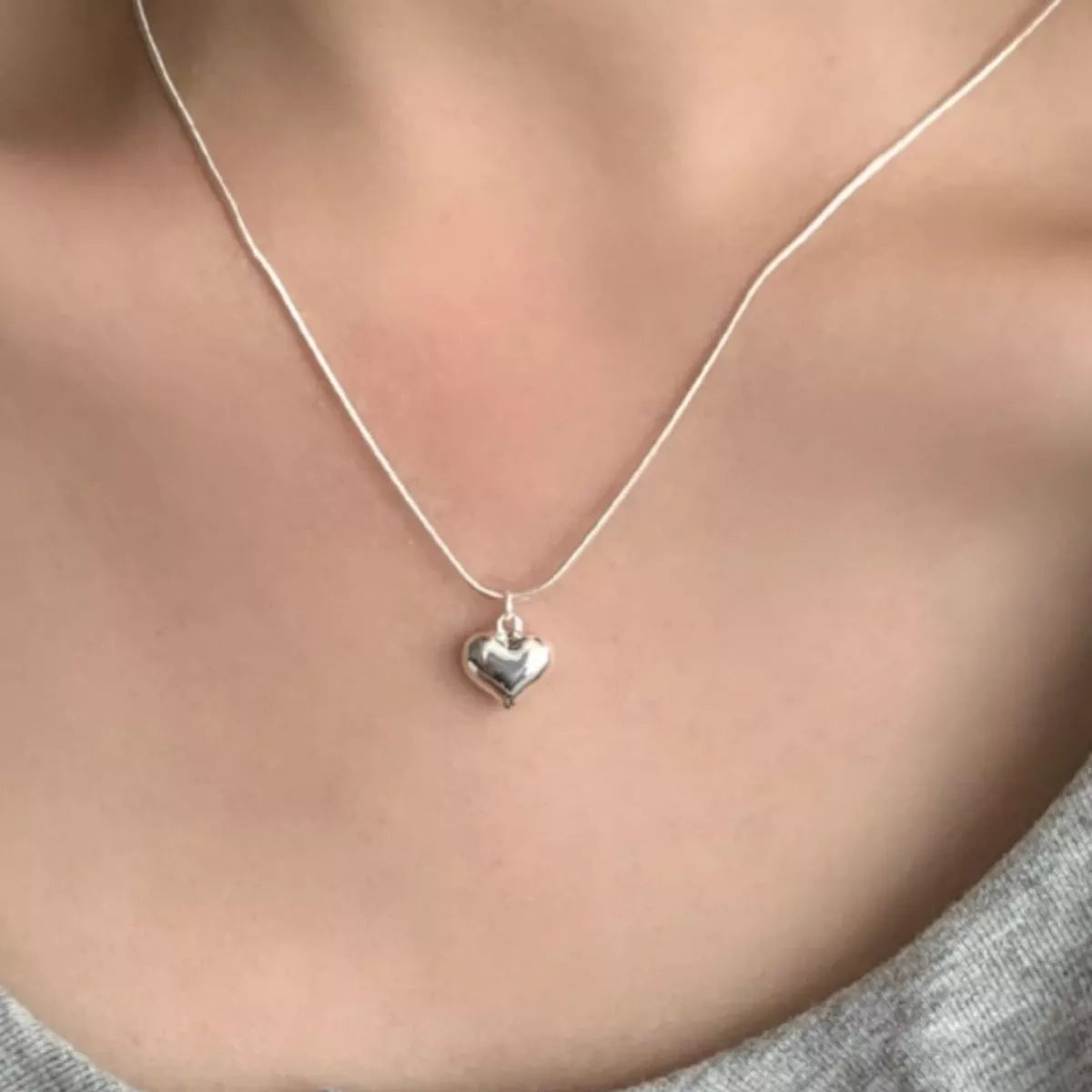 Sterling silver heart necklace from Plush Fashion Hub featuring a delicate chain and a polished heart pendant.