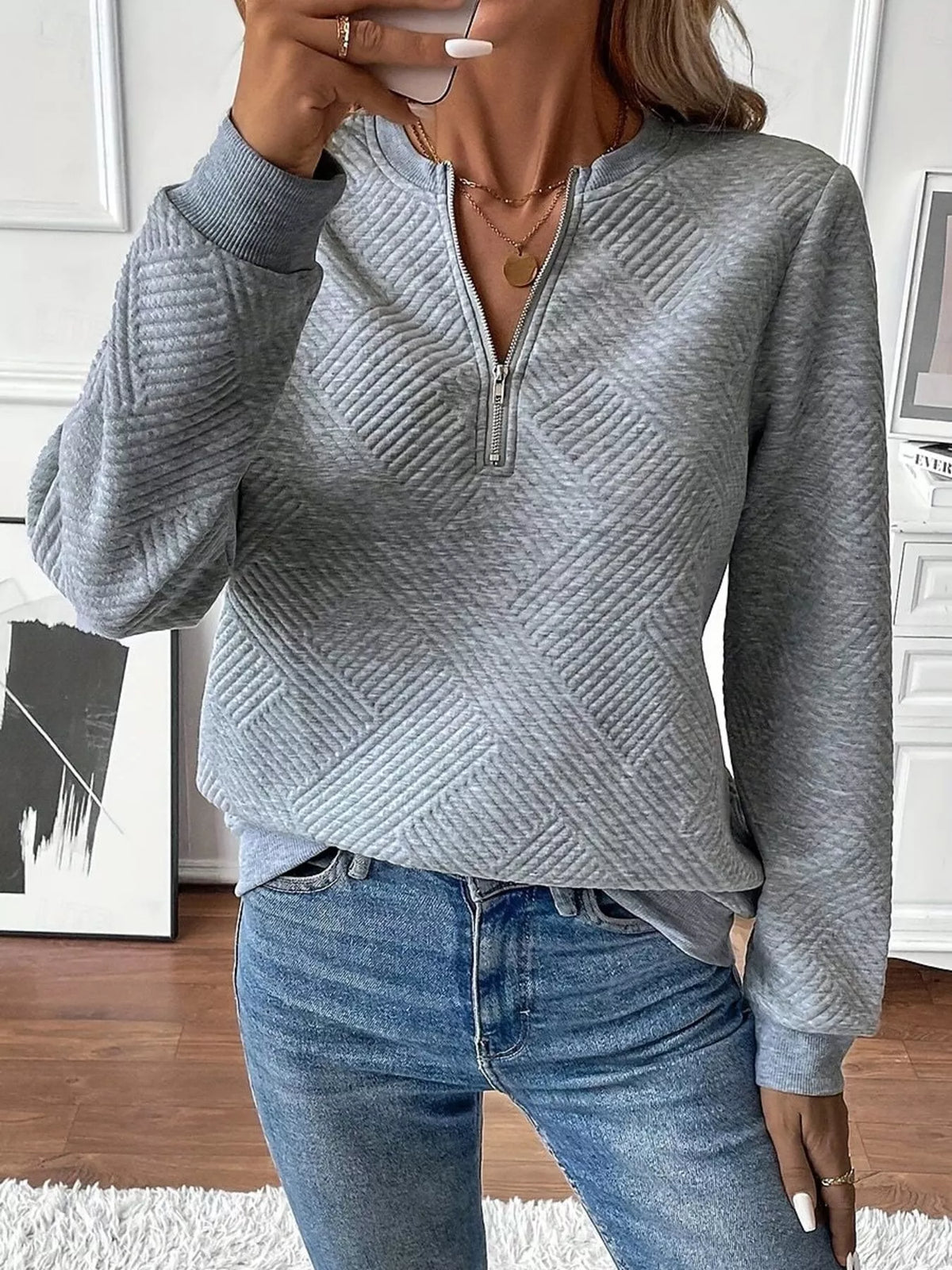 Textured women's quarter-zip sweatshirt by Trendsi featuring a stylish fit and cozy fabric, displayed on a model.