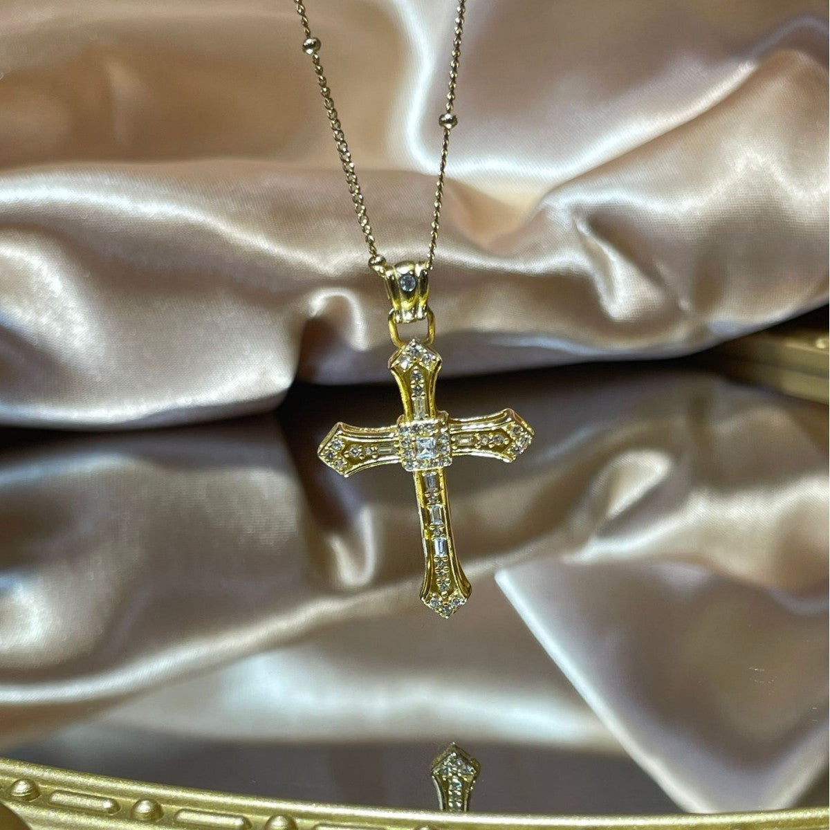 Gold-plated cross pendant necklace from Plush Fashion Hub featuring a sleek design on a delicate chain.