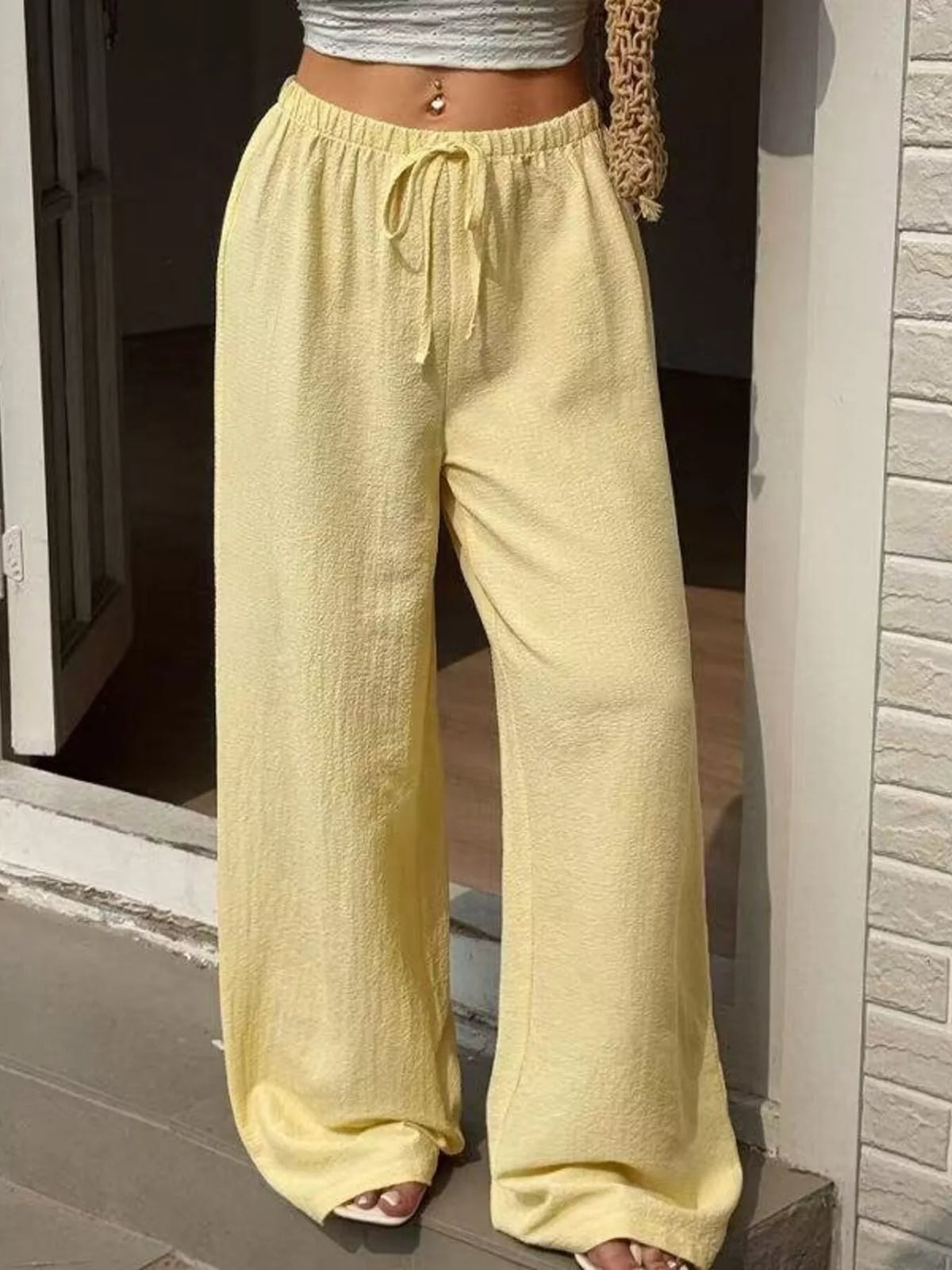 Plus size high-waisted wide-leg pants from Plush Fashion Hub, shown in black with a relaxed fit and flowing silhouette.